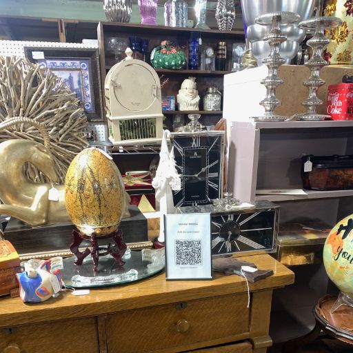 Flea market vendor booth with QR code for customer questions